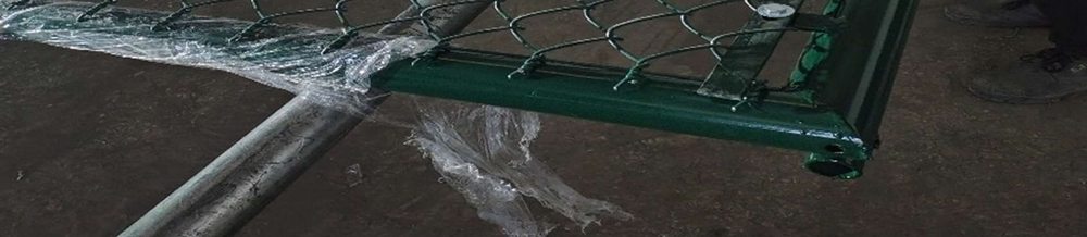 Close-up of a green chain-link fence gate frame